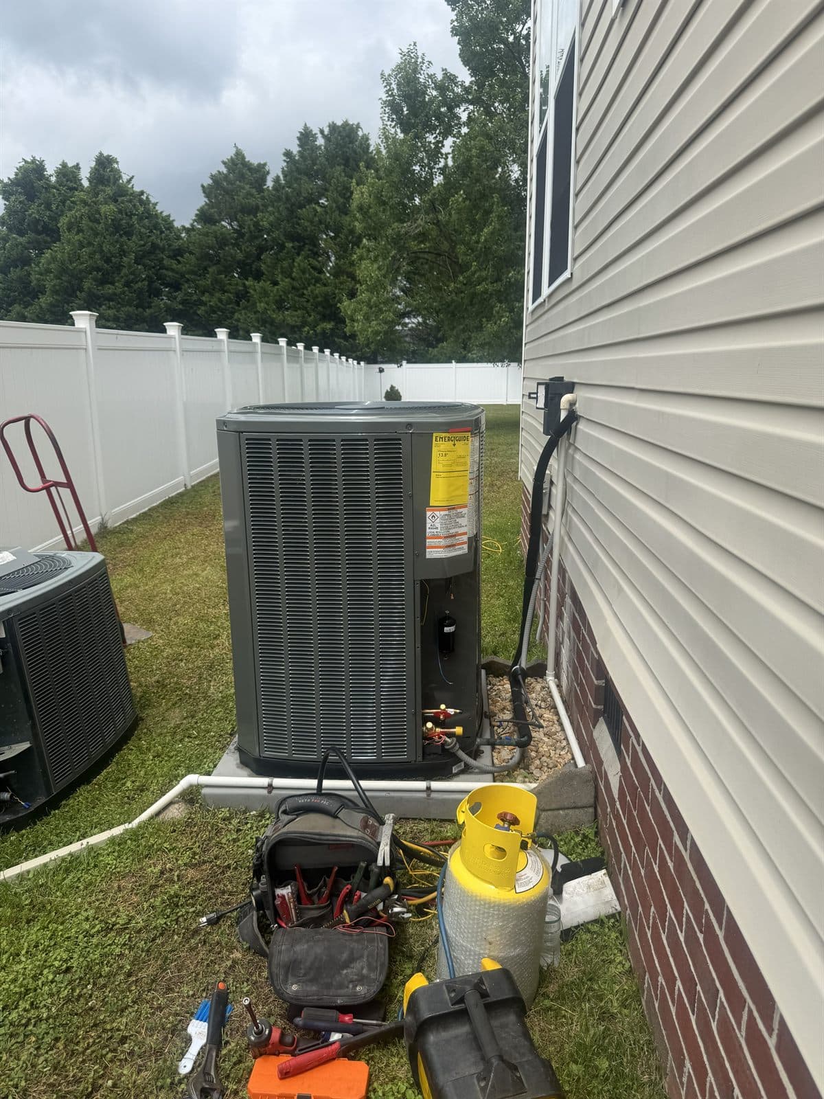 New Trane condenser being commissioned with tools on the pad