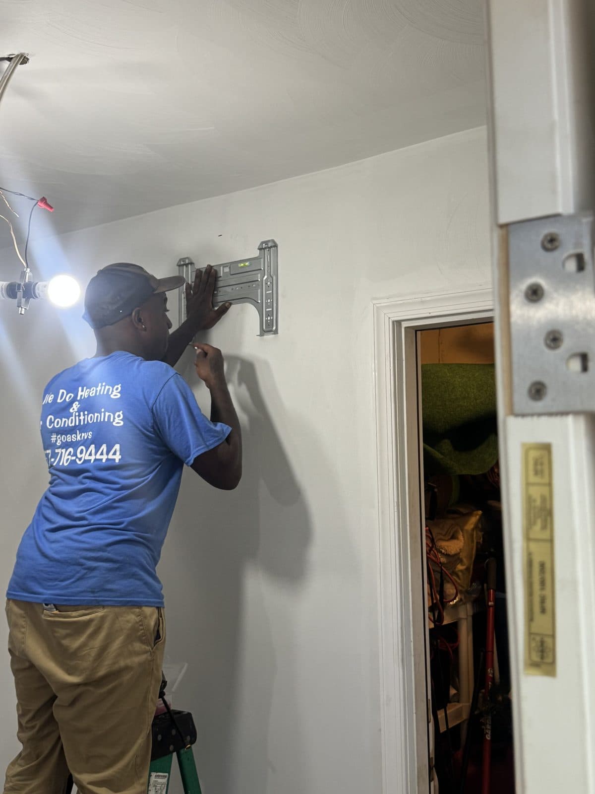 RedVine technician leveling and fastening the mounting bracket for the mini-split indoor unit